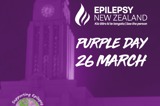 A clocktower building coloured purple with text announcing Epilepsy NZ's Purple Day on 26 March 2026