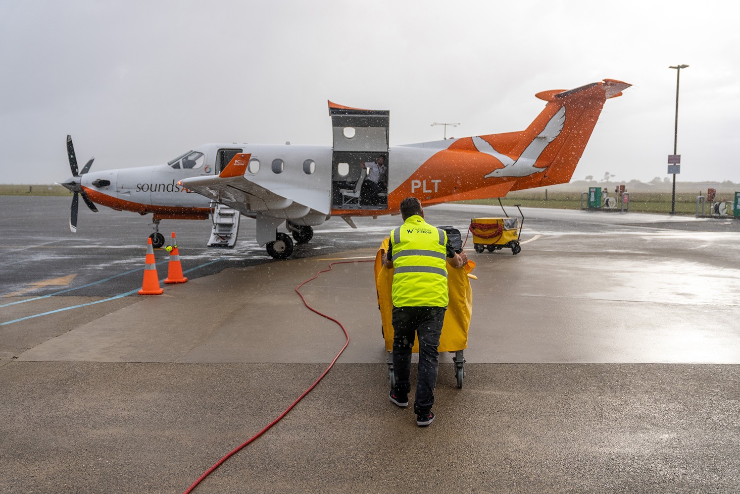 Westport Airport staff loading luggage on plain