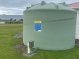 Water storage tank installed on a green field