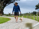 man walking dog at carters beach