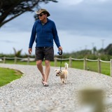 man walking dog at carters beach