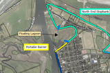 Aerial view showing the location of a proposed stopbank around a lagoon area adjacent to a port and residential housing